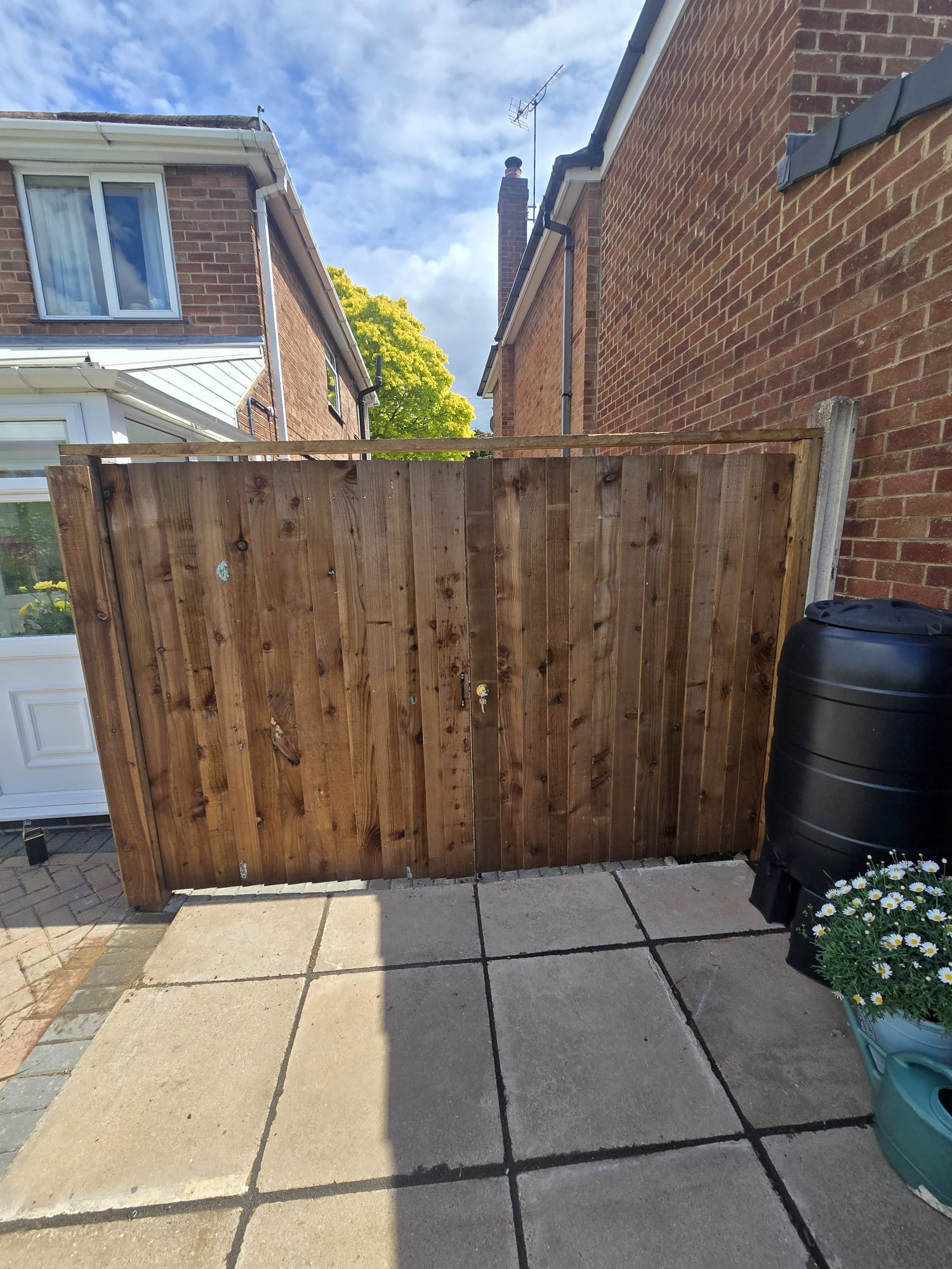 Wooden gate between brick houses
