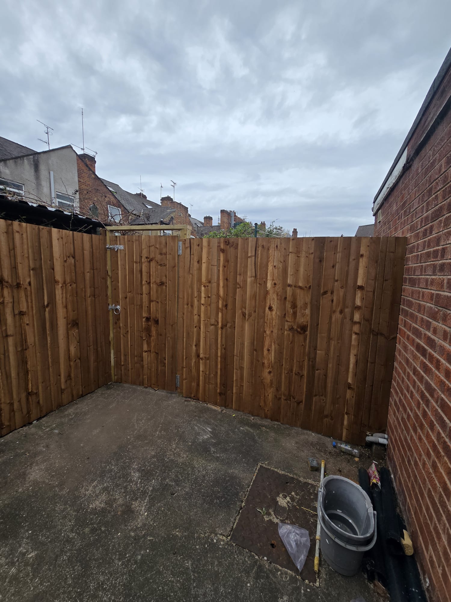 Fence enclosure with brick wall